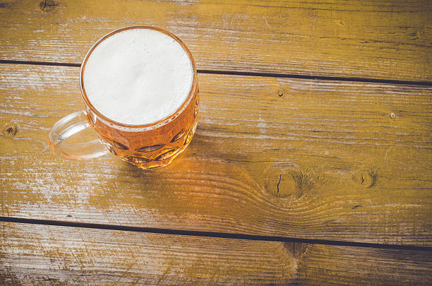 istock Beer glass on an old yellow wooden table 526830884