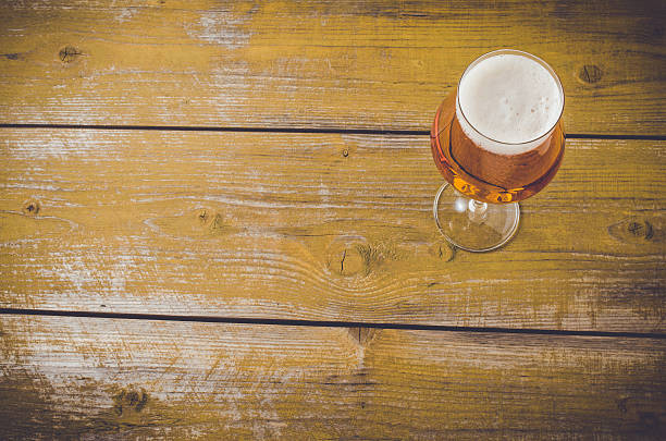 istock Beer glass on an old yellow wooden table 526831088