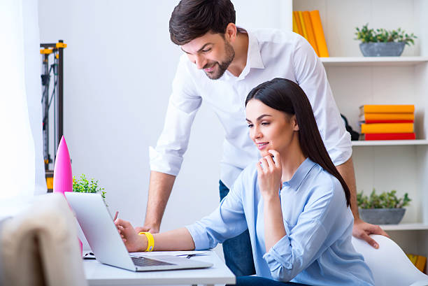 istock Positive colleagues working on the laptop 526832262