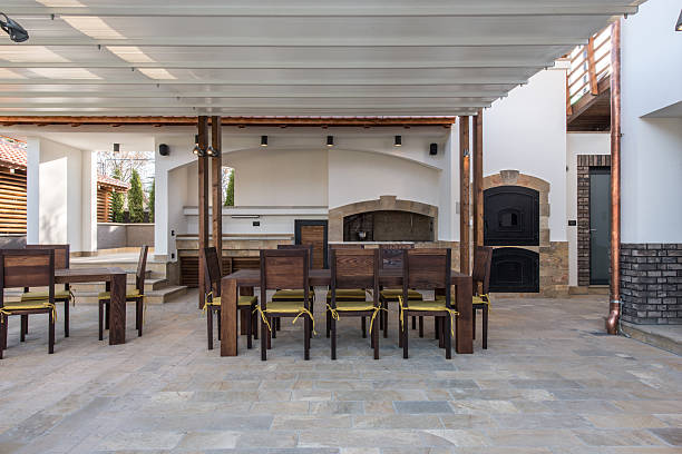 istock Long table and chairs on veranda in luxury villa exterior 526833638