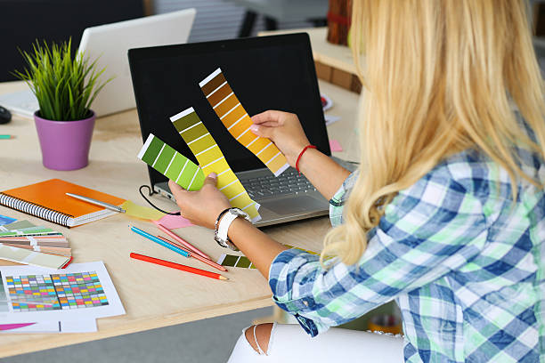 Hands of female designer in office Hands of female designer in office working with colour samples. Woman at workplace choosing colourful paper charts. Creative people or advertising business concept design color swatch painting plan stock pictures, royalty-free photos & images