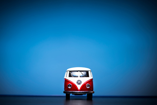 Izmir, Turkey - December 5, 2014: Red Toy Volkswagen Microbus Van front view and blue background. December 04 2014 Izmir Turkey. Volkswagen is a German automobile manufacturer.