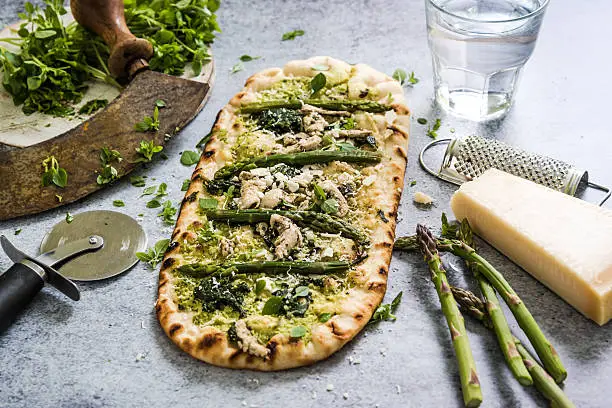 Photo of Pizza with fresh spring vegetables and herbs