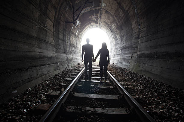 istock Couple walking together through a railway tunnel 526836160