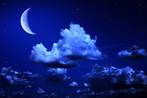 istock Big moon and stars in a cloudy night blue sky 526836163