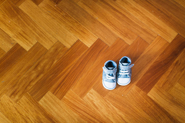 istock Infant shoes on wooden floor 526836725