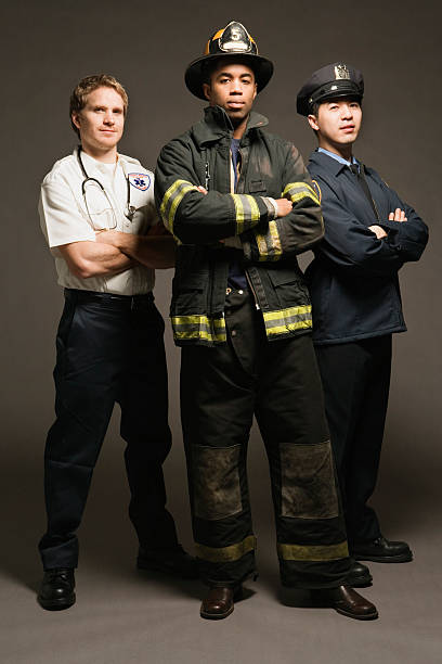 Police officer, paramedic and fireman, on black background, portrait Police officer, paramedic and fireman, on black background, portrait police and firemen stock pictures, royalty-free photos & images
