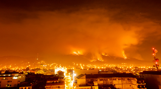 photographs taken of a mountain fire in a city, which means more pollution by climate change