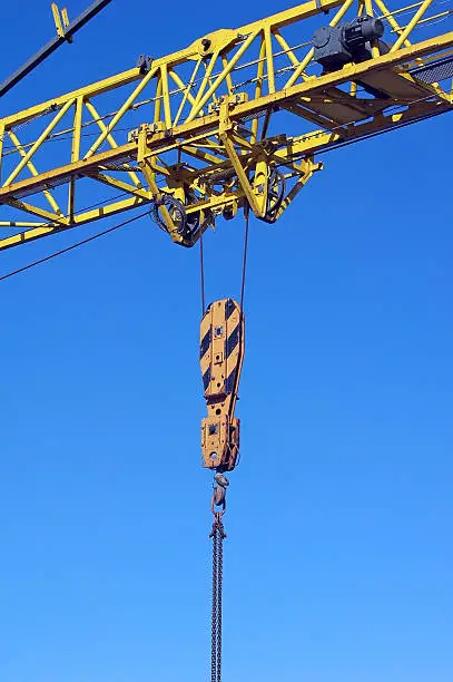 yellow industrial crane isolated on blue sky