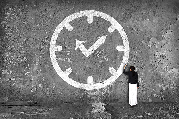 istock businesswoman drawing  clock on the wall 526839595
