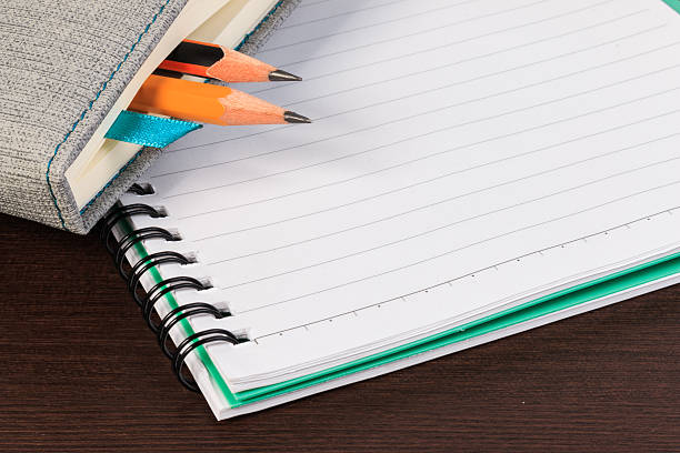 istock Blank notebook and pencil on dark wooden table. 526839660