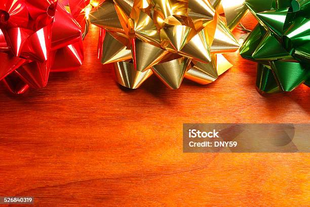 Multi Colored Christmas Bows On Wood Surface Stock Photo - Download Image Now - Ribbon - Sewing Item, Satin, Border - Frame