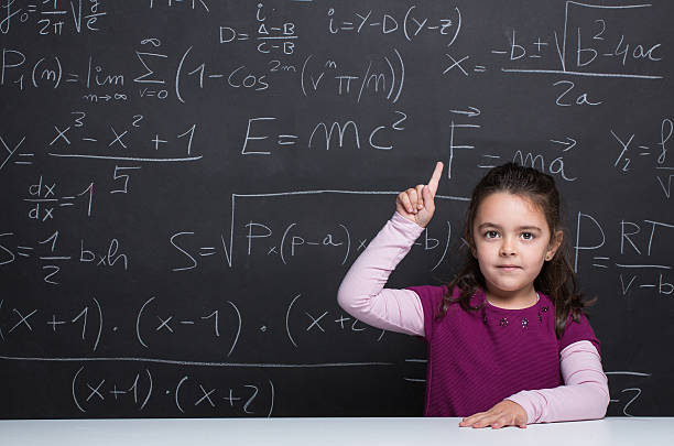 istock Little girl against blackboard. 526840889