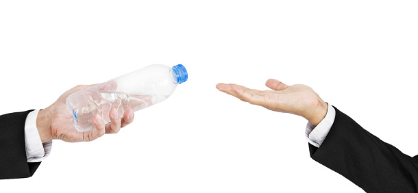 Hand of businessman holding, giving, receiving bottle of water, isolated on white background