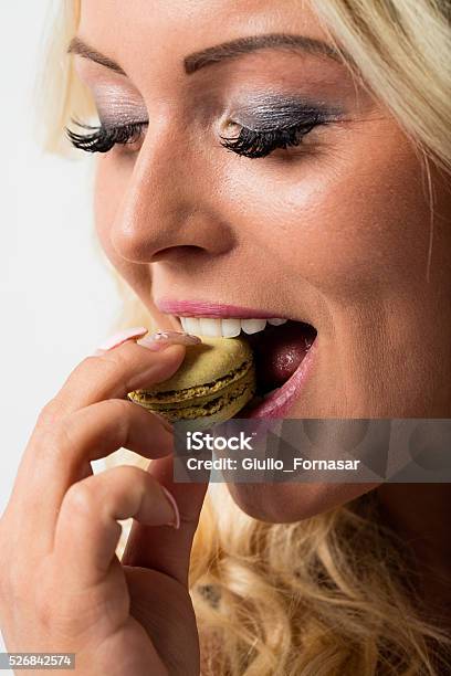 Woman Eating Macaron And Falling In Love With It Stock Photo - Download Image Now - Greed, Adult, Baked Pastry Item
