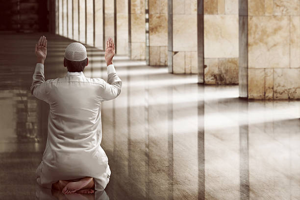 Religious muslim man praying Religious muslim man praying inside the mosque haji stock pictures, royalty-free photos & images