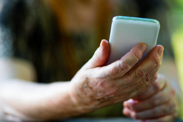 istock old woman holding a mobile phone 526845270