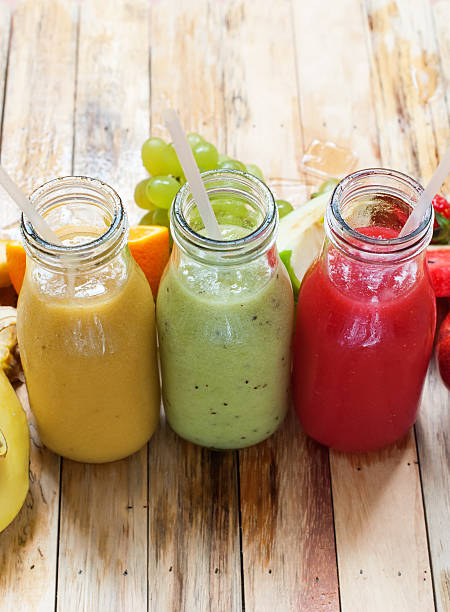 istock Row Juices Smoothie Bottles Red Green Orange Fruit 526845520