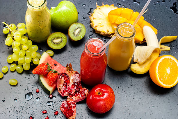 istock Red Green Orange Fruits Smoothie Black Background 526845916