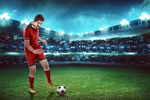 istock Asian football player kick ball 526846058