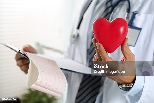 Male Medicine Doctor Hands Holding Red Toy Heart Stock Photo - Download Image Now - Cardiologist, Pacemaker, Cardiac Arrhythmia