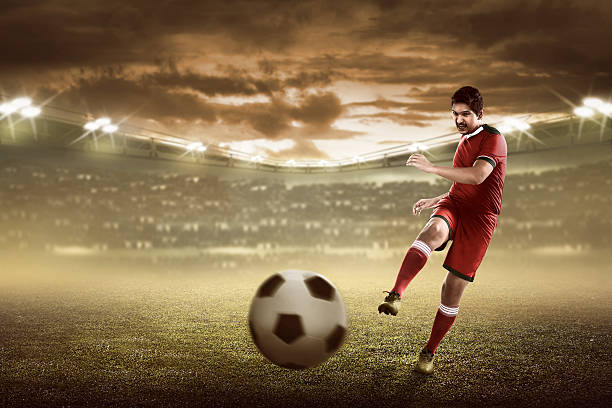 istock Asian football player kick ball 526846214