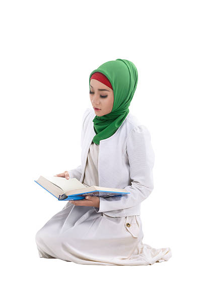 istock Muslim woman reading koran 526847150