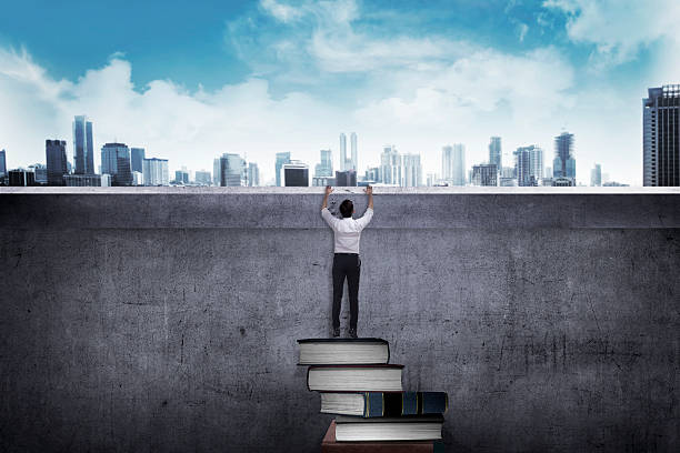 istock Asian business man climbing book 526847782