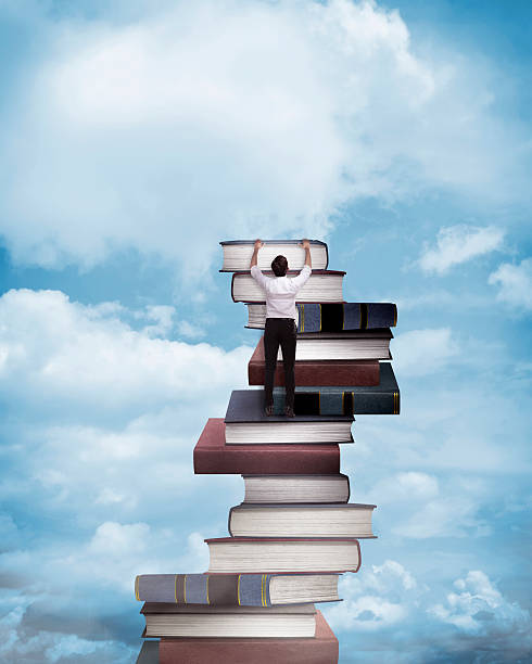 istock Asian business man climbing book 526847878