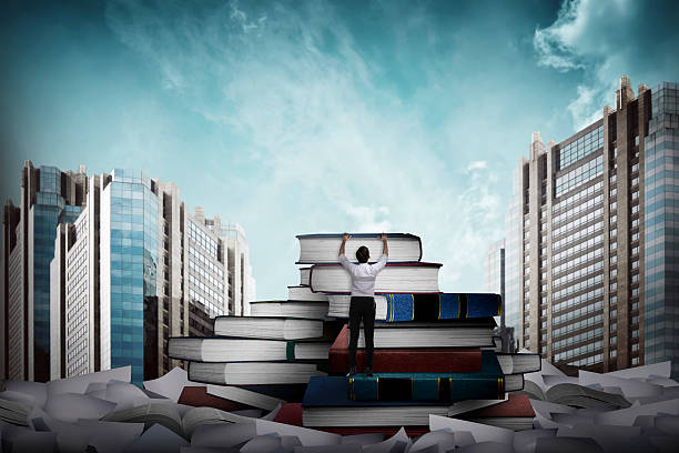 istock Asian business man climbing book 526847932