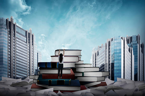 istock Asian business woman climbing book 526848016