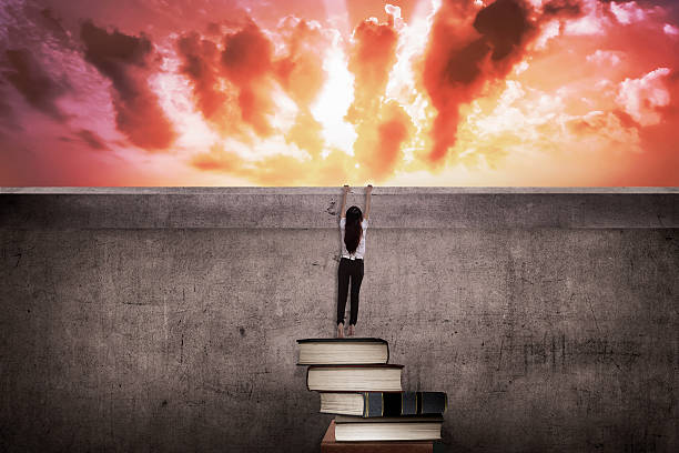 istock Asian business woman climbing book 526848192