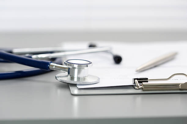 istock Stethoscope head lying on medical form on clipboard pad 526850150