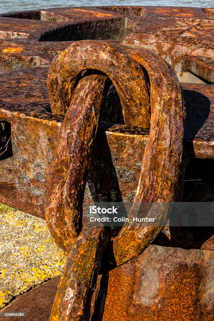 Rusty Chain An old rusty chain attached to a capstan on an old pier in Aberdeen harbor. Aberdeen Harbor Stock Photo