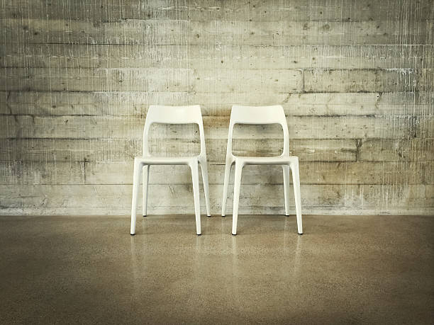 istock White chairs near concrete wall 526857305