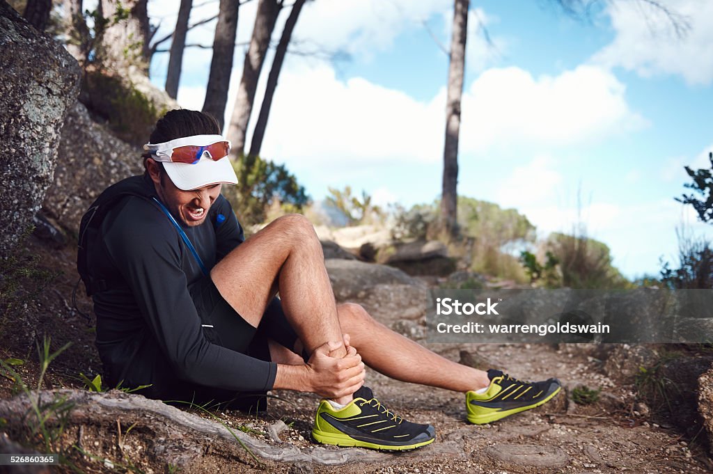 painful running injury running injury for trail runner on mountain twisted ankle Physical Injury Stock Photo