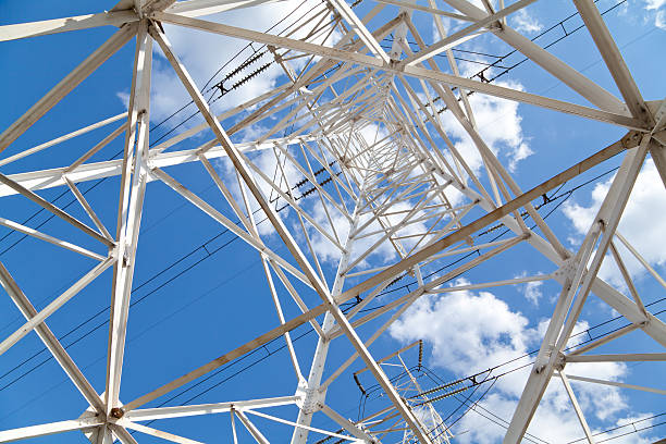 istock Bottom view power transmission lines against blue sky 526879601