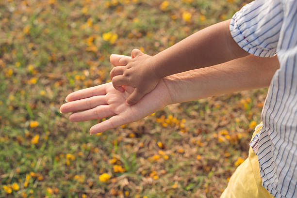 istock Hands of mother and child 526880637