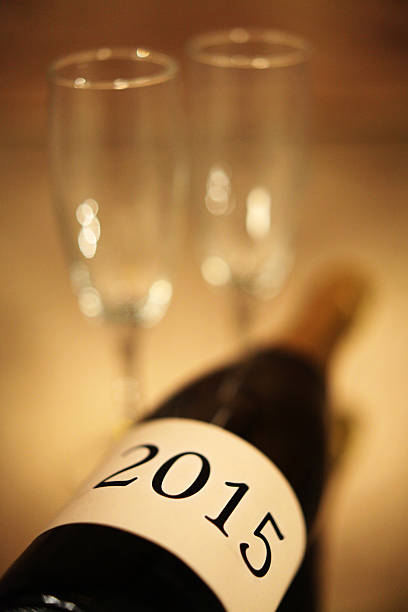 istock Champagne Bottle New Years 2015 with Flutes 526881083