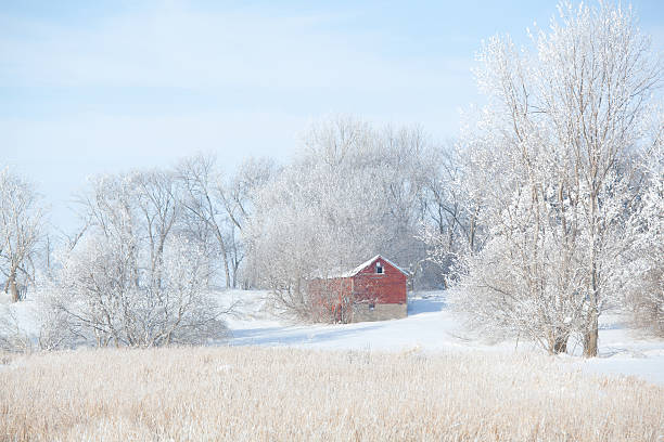 Red Barn Farm Winter Snowy Scene Subject: Winter idyllic landscape scene with red barn and farm field in the foreground. red barn house stock pictures, royalty-free photos & images