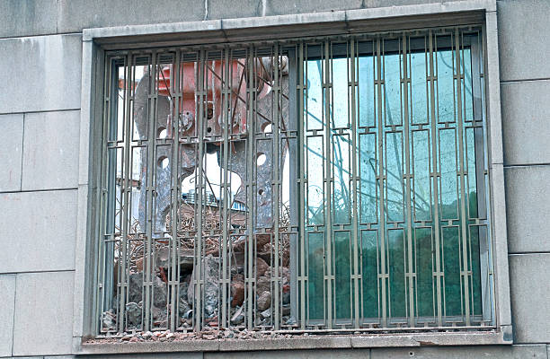 istock Crane's shearing tool visible through window of building being demolished 526882827