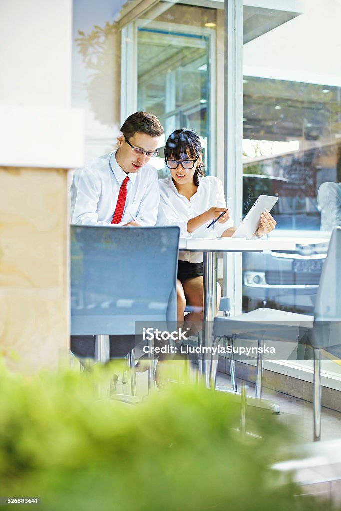 Man and woman working together White-collar workers sitting at the table in the office discussing a project, Bali Large Stock Photo