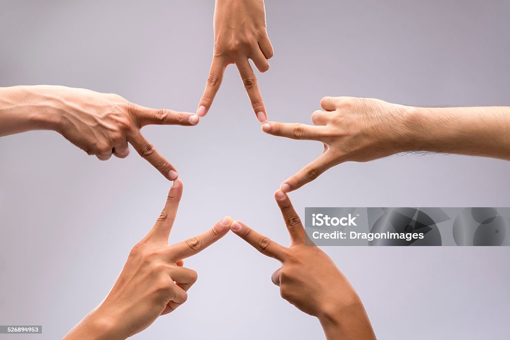 Forming star shape People forming star shape with their fingers Star Shape Stock Photo