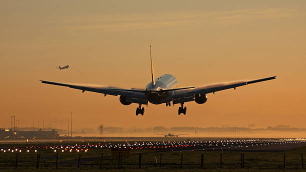 istock Airplane landing sunrise 526895739