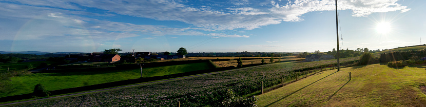Panoramic landscape of fields, rolling clouds, summer evening, captured in Ireland around Belfast, july 2014