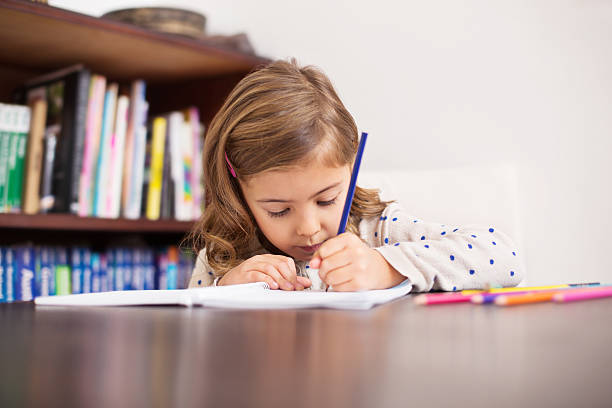 istock Cute little girl drawing 526898099