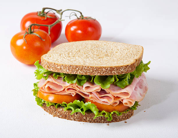 Ham Sandwich Ham or Turkey Sandwich with tomato on white background sandwich club sandwich lunch restaurant stock pictures, royalty-free photos & images