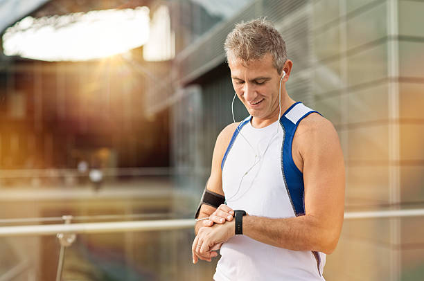 istock Male Athlete Looking At Watch 526899869