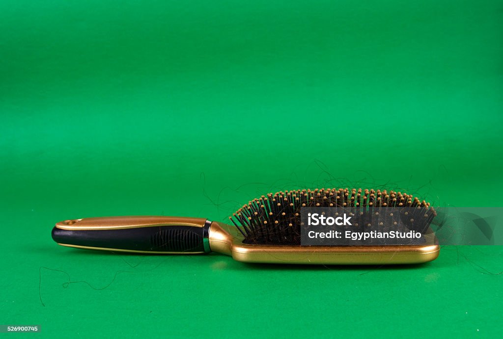 Close-up of a hairbrush with lost hair in it Alopecia Stock Photo