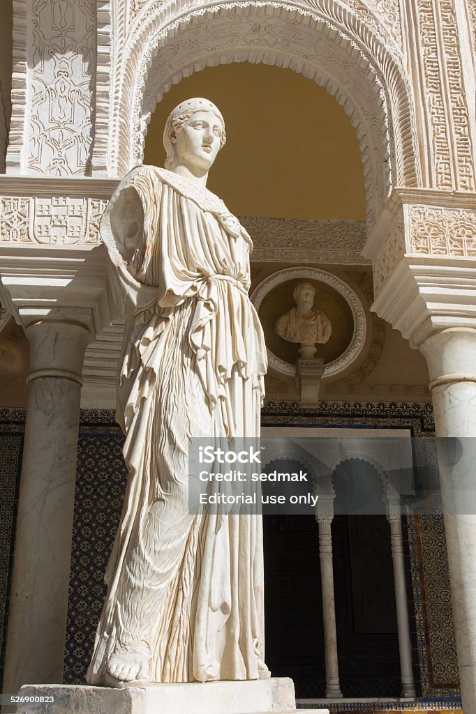 Seville - statue Pallas Pacifera in House of Pilate. Seville, Spain - October 27, 2014: The copy of antique statue Pallas Pacifera by unknown artist in the Courtyard of Casa de Pilatos. The building is a mixture of Renaissance Italian and Mudéjar Spanish styles.  Casa De Pilatos Stock Photo